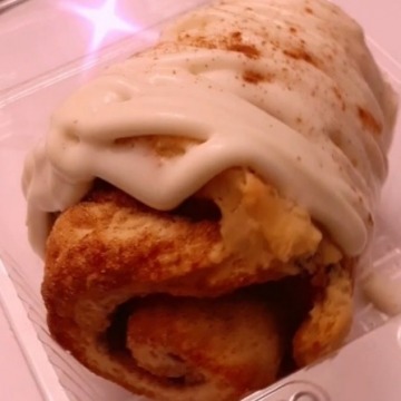 Original Gangsta Cinnamon is a giant southern cinnamon topped with a hefty amount of cream cheese icing and finished with fresh cinnamon.